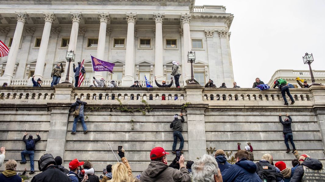 Photo of Capitol breach on January 6th, 2021. Trump’s followers are climbing the walls of the U.S. Capitol Building.