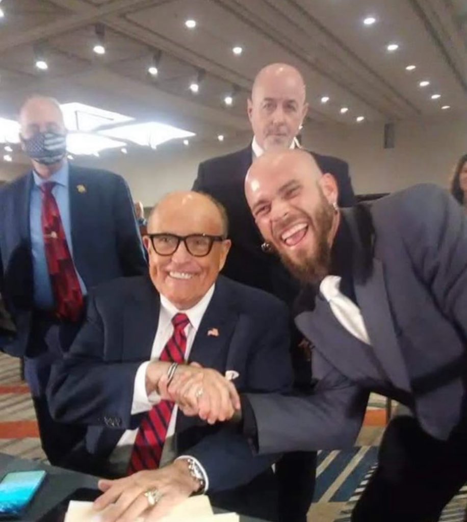 This man, who is pictured with both Nancy Pelosi’s son-in-law and Rudy. I have heard he is a marine, but I can not confirm.