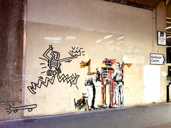 5) Days before a major 2017 Basquiat exhibition at a London gallery, Banksy drew a figure being frisked by two police officers. He captioned it with "Portrait of Basquiat being welcomed by the Metropolitan Police – an (unofficial) collaboration with the new Basquiat show."