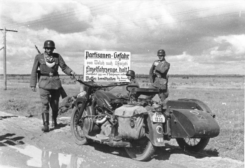 Thread: Members of the Wehrmacht Feldgendarmerie erecting a sign on a major road in Russia, July 1941. This was not just any highway, however. Later in 1942, what happened along and beyond this road would have a severe effect on the Army Group Centre Rear Area. (Photo: BA)