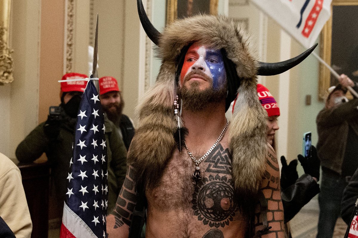 RollingStone's tweet image. Is the "QAnon Shaman" from the MAGA Capitol riot covered in Neo-Nazi imagery? rol.st/3s8PQ2b