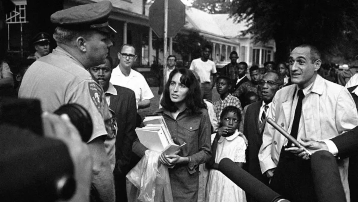 Joan Baez escorting black kids to school in Mississipi, 1966
