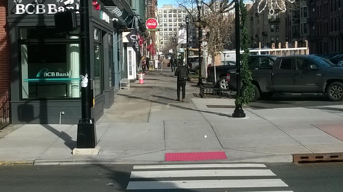 ItsANewWorld4's tweet photo. Hello - @CityofHoboken  - Walking up the left side of Wash St at 11th, on the corner of the BCB Bank, I noticed the street crossing light was tilted away at an angle. A delivery truck may have nudged it. In any case, pedestrians can't see it head on now. https://t.co/Jhf7dyFop3