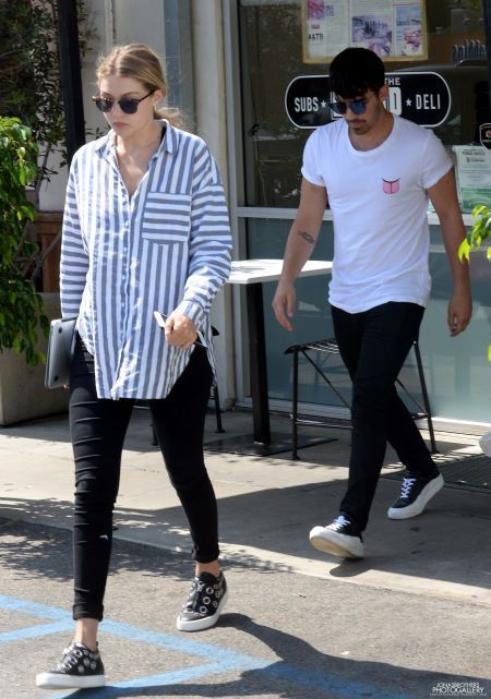 Joe and Gigi dancing, hugging and kissing each other.