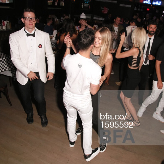 Joe and Gigi dancing, hugging and kissing each other.