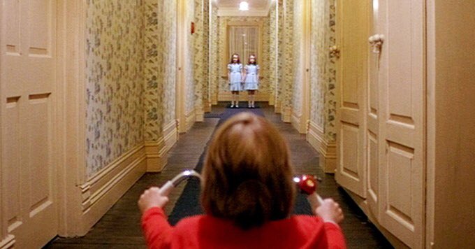 the music video starts with a slow tracking shot in a hallway, that is so reminiscent of The Shining, and tracking and panning shots build suspense because it makes one feel like the subject is being watched and one’s dread builds up as the camera follows them.(s : the shining)