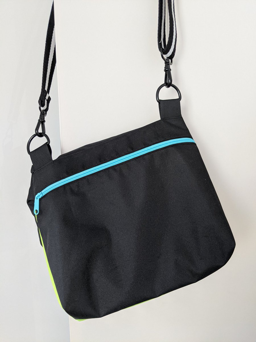 The rear view of the bag showing zip pocket with blue zip