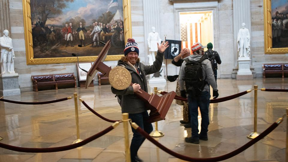 Forbes's tweet photo. Adam Johnson—the man photographed in the Capitol carrying House Speaker Nancy Pelosi’s podium—was among those arrested after the insurgency https://t.co/cu56Q94Hgp https://t.co/pNkqEN1f75