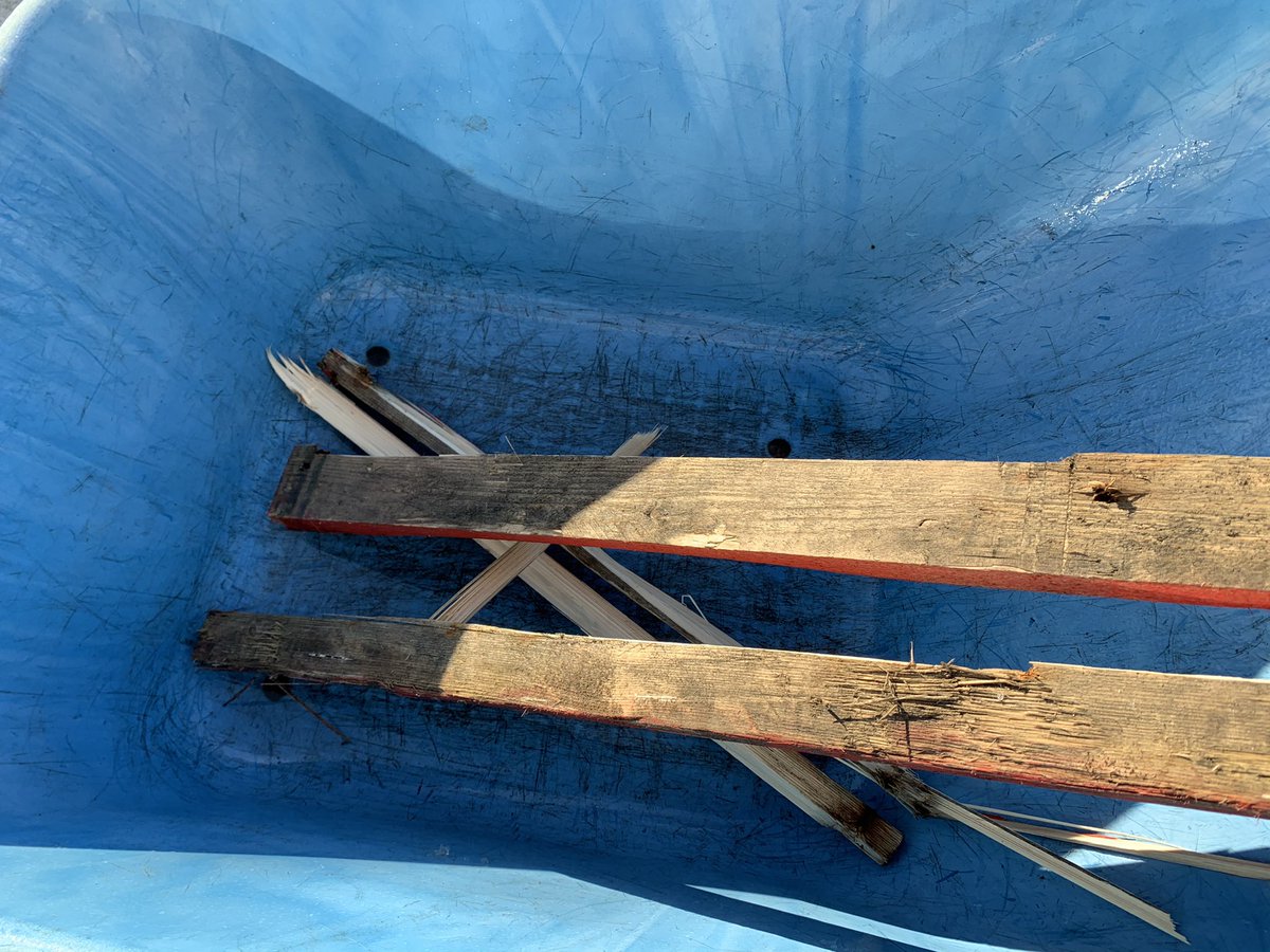 Taking the pallet apart the hard way. We tried to just pry the boards off at the corners. The boards were just breaking...