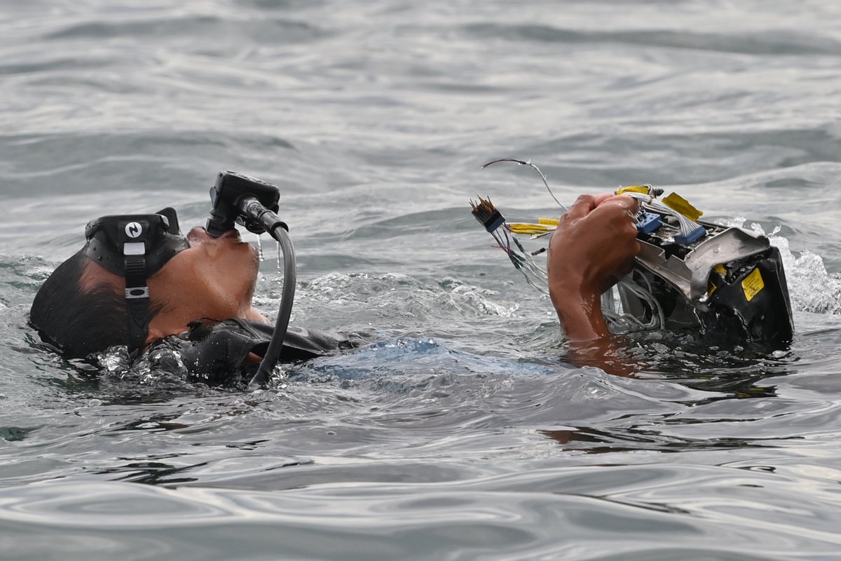 inquirerdotnet's tweet photo. LOOK: Indonesian Navy divers hold wreckage from Sriwijaya Air flight SJY182 during a search and rescue operation at sea near Lancang island on January 10, after the Boeing 737-500 crashed shortly after taking off from Jakarta airport on January 9. | 📷 Adek Berry/AFP https://t.co/IZcBp0bbIu