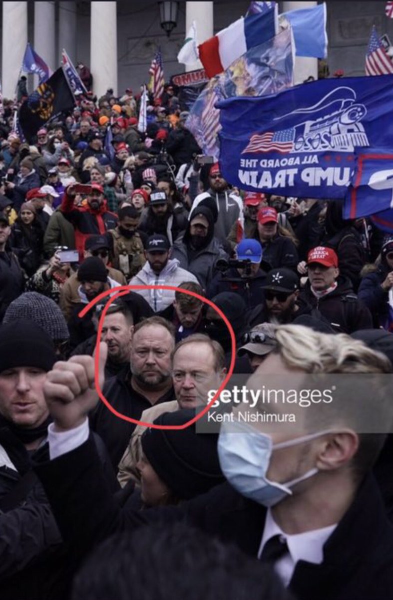 Kinda interesting. Check the fancy over coat in the sea mask-less rioters. Journalist? Onlooker? Secret Service?