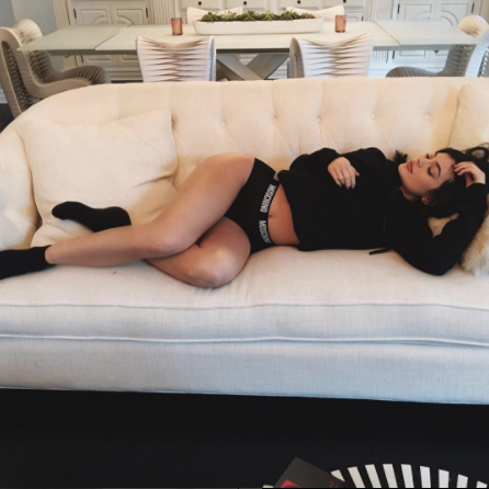 kylie jenner manages to fit her entire body onto a chair. is she sitting? even a toddler would agree that no, she is not. but she is grateful for this progress and takes a moment from all her hard work to bask in it