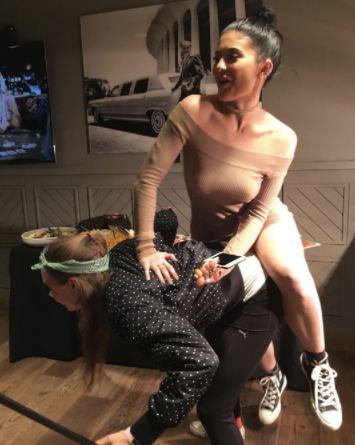 overconfident from her recent successes, kylie mistakes fellow clothes wearer for a chair and attempts to sit on her. it's hard to watch 