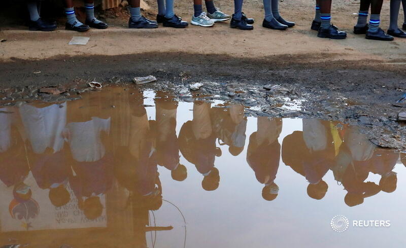 Schoolchildren wait to have their temperature checked before entering Olympic Primary School as it reopens in Kibera slums of Nairobi, Kenya, after forced coronavirus closures. More photos of the week: reut.rs/3q8z01X 📷 <a href="/tmukoya2002/">Thomas Mukoya</a>