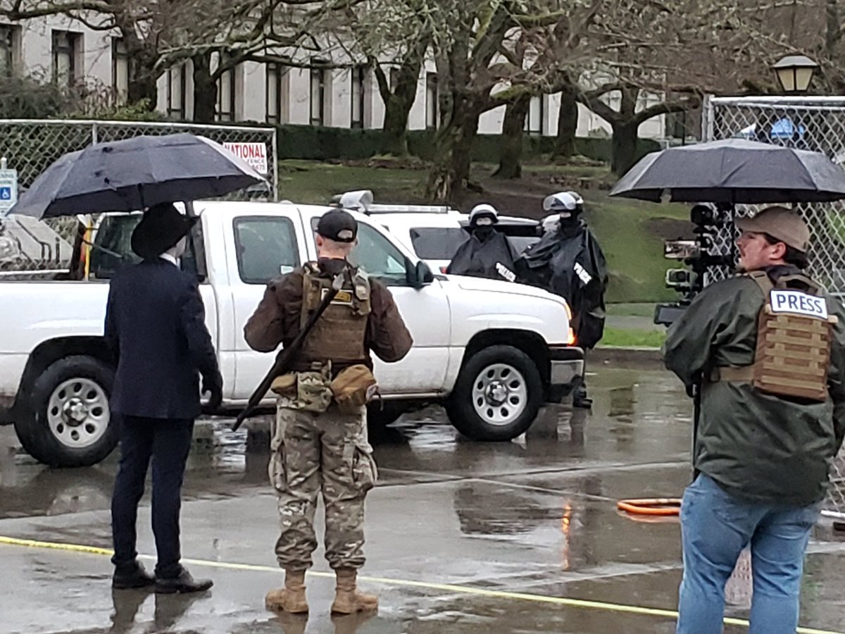 About 2 dozen people here staring at Washington State Patrol and National Guard. I've seen at least 2 long guns in the crowd so far. &ndash; bei  Washington State Capitol
