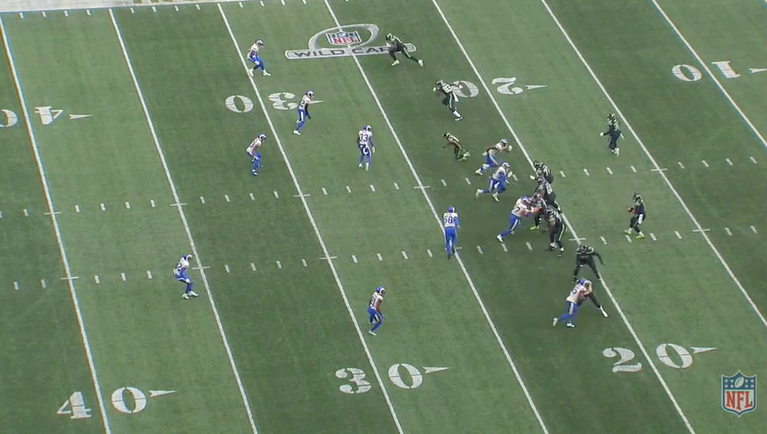 Immediately post snap58 for the Rams (at the near 25) pays no attention to Hollister chipping and releasing at the bottom of the image. He sprints across the formation to a specific spot.