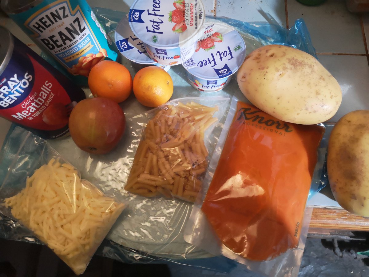 KirstyWarner's tweet photo. @RoadsideMum Nothing from my eldest's secondary school.
Picked up my youngests today which for 5 days consists of pk of tortilla wraps, 3 yoghurts, beans, meatballs, 2 potatoes, sml pouch cheese, pasta &amp; soup, 2 of the tiniest clementines &amp; a small apple. She would have loved more fruit. https://t.co/yg6F328oWE