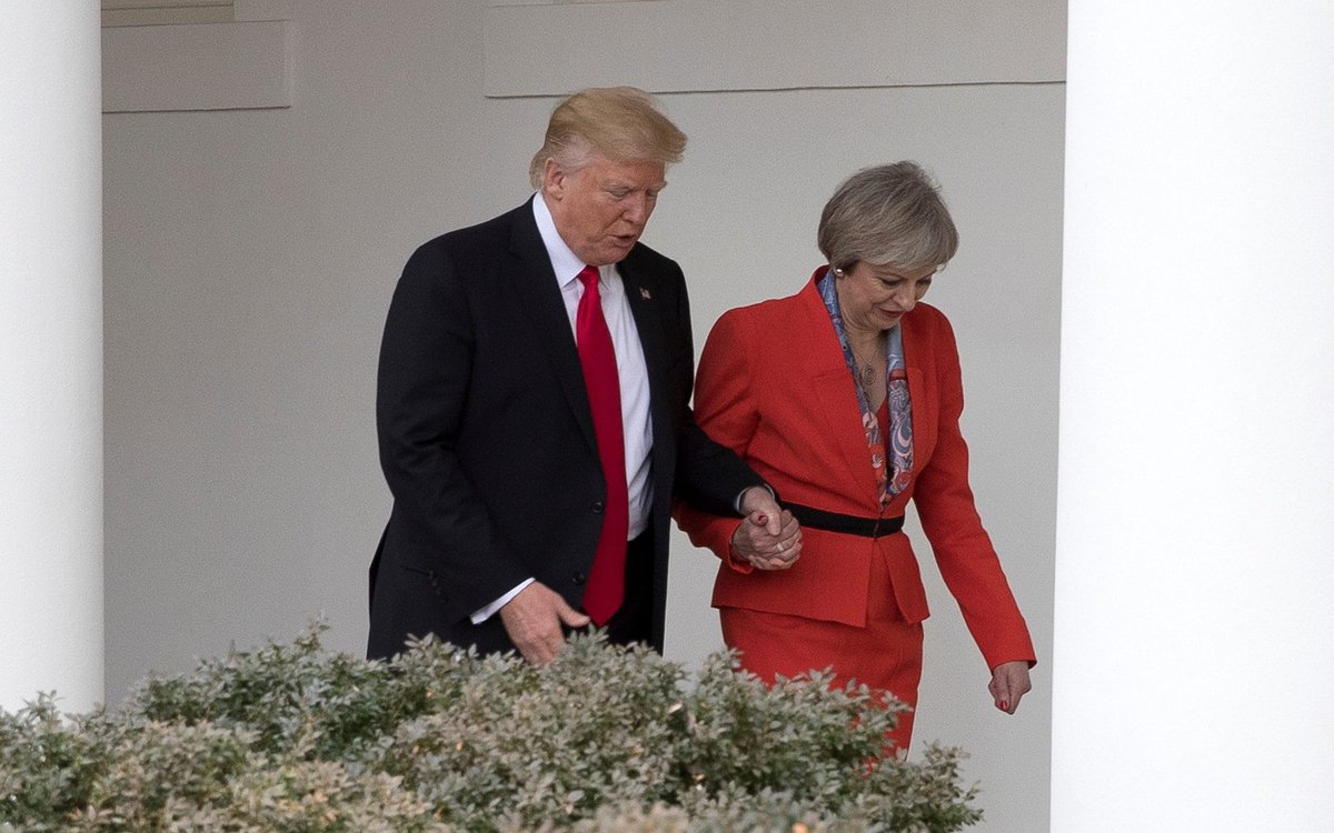 HOLDING HANDS LIKE A TODDLER WITH THERESA MAY