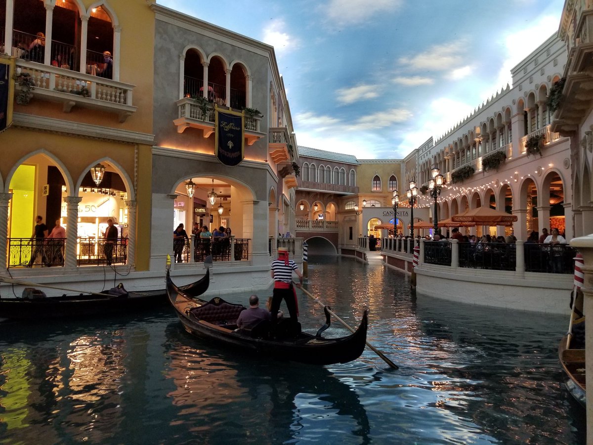 Picture of a canal with buildings surrounding it. At the Venetian in Vegas.