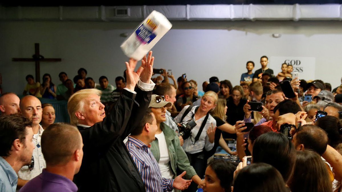 THROWING PAPER TOWELS INTO THE CROWD AFTER A DEVASTATING HURRICANE IN PUERTO RICO