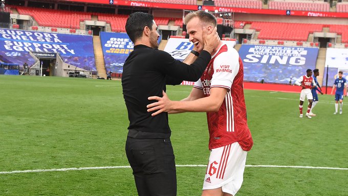 Rob Holding and Mikel Arteta embrace on the Wembley pitch after winning the Emirates FA Cup