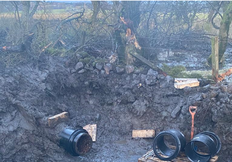 scottish_water's tweet photo. This is a view from 4PM of the repair to the burst pipe in the #Falkirk area impacting on properties in #FK1 and #FK6 . The new section of pipe is now being fitted and we are on track for completion of repair. https://t.co/X8xCYXDYr3