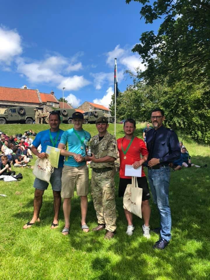 ClevelandHike's tweet image. Back in 2019 it was sunny, the Cleveland Hike was very well attended and supported by #LNER and #TheRifles and many others.  Who can name the team receiving the trophy 🏆 from Commander 4 Brigade ... #namethatperson