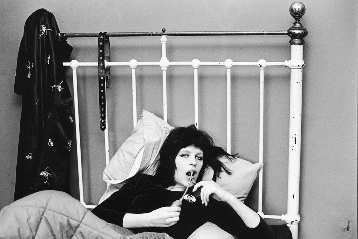 Judy Nylon in bed with atomizer, London, 1976.Photo by Kate Simon
