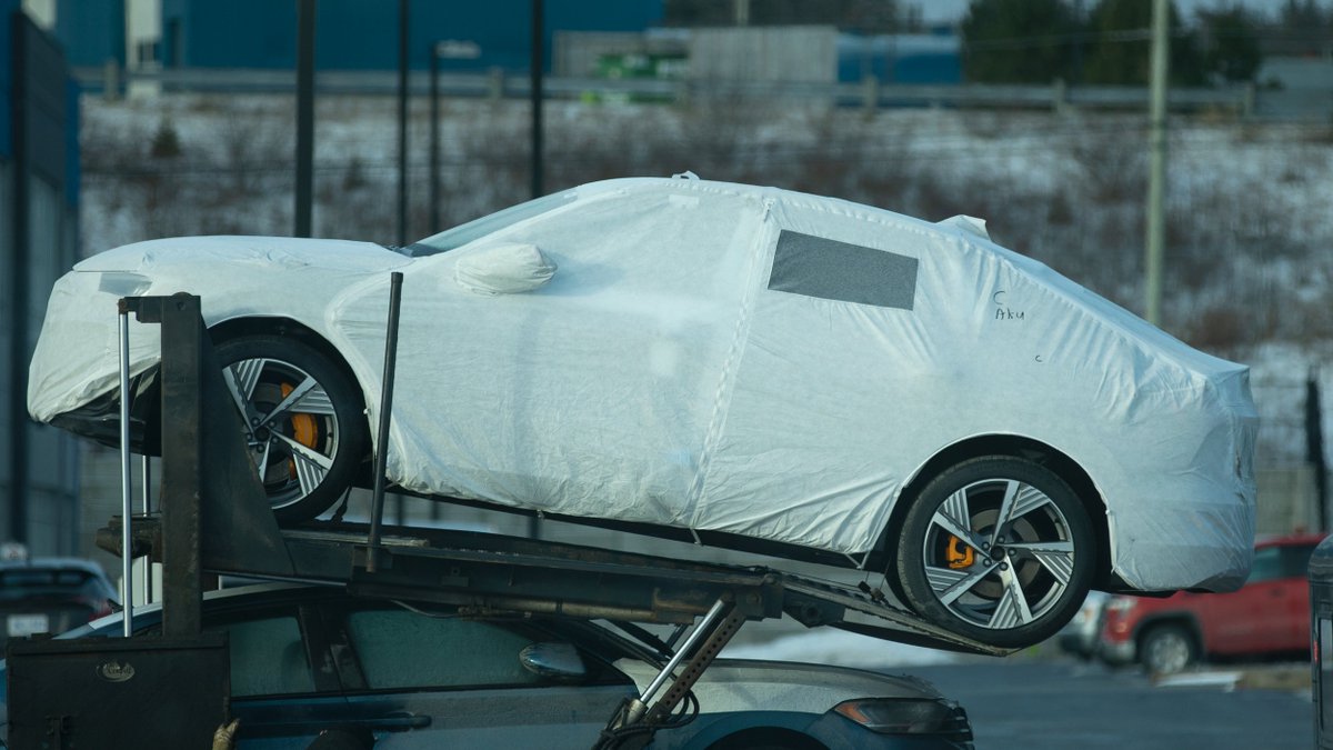 AudiStJohns's tweet photo. A very special car has just landed and is waiting to be unloaded and unwrapped. The yellow rotors and wheel combination are a sure giveaway for Audi electric car enthusiasts. https://t.co/hcPVyxyaqh