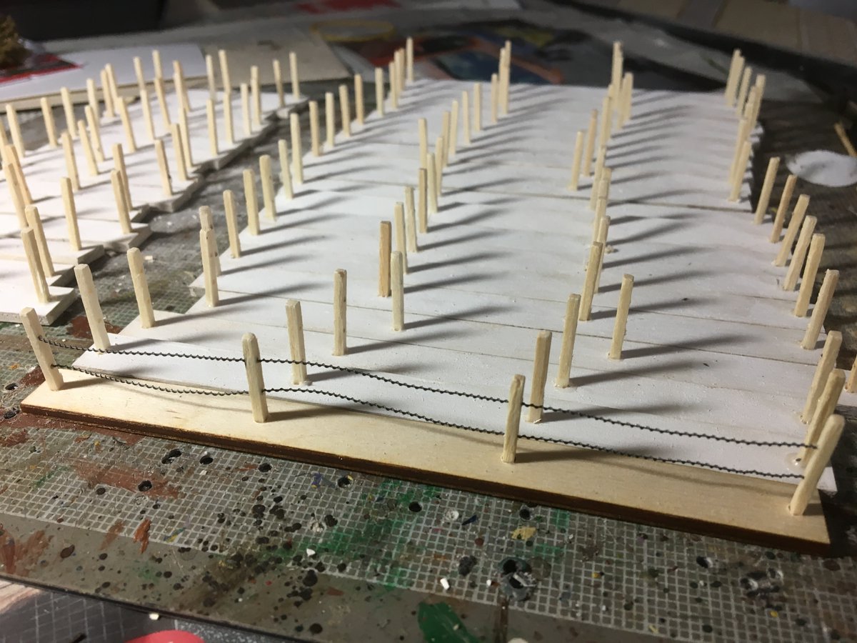 Here's where I went a little nuts. A friend cut 1/8 plywood on his laser cutter, I drilled holes for the matchsticks 6" and 3" sections. I drilled out the matchsticks to thread the barbed wire through. Painted them white, I built 13' of these, 114 matchsticks drilled twice. Crazy
