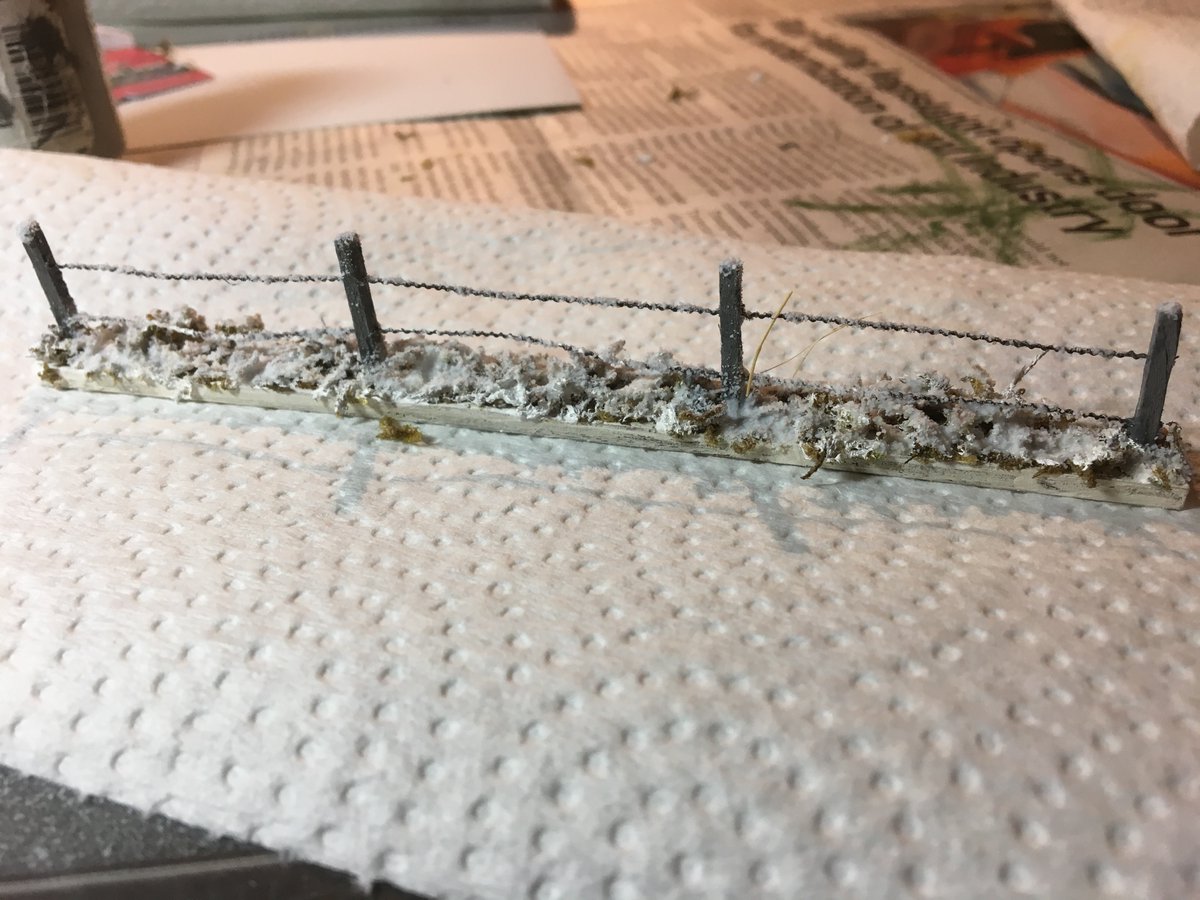 Here's where I went a little nuts. A friend cut 1/8 plywood on his laser cutter, I drilled holes for the matchsticks 6" and 3" sections. I drilled out the matchsticks to thread the barbed wire through. Painted them white, I built 13' of these, 114 matchsticks drilled twice. Crazy