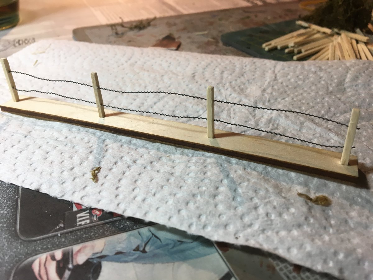 Here's where I went a little nuts. A friend cut 1/8 plywood on his laser cutter, I drilled holes for the matchsticks 6" and 3" sections. I drilled out the matchsticks to thread the barbed wire through. Painted them white, I built 13' of these, 114 matchsticks drilled twice. Crazy