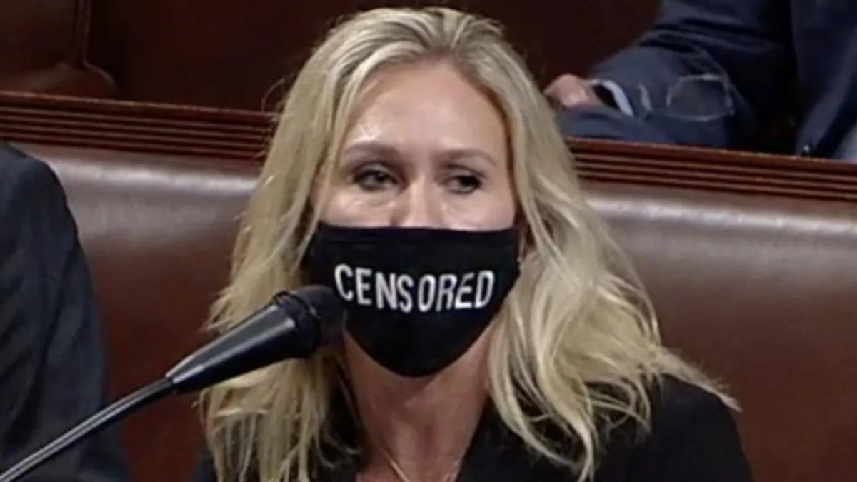 tytempel's tweet photo. Q-anon idiot cheerleader Marjorie Taylor Green of Georgia wearing a "censored" mask while speaking on the House floor -- words forever recorded in the Congressional Record is hardly being "censored" there, Marge.

#GOPComplicitTraitors https://t.co/F4kpt5UiCP