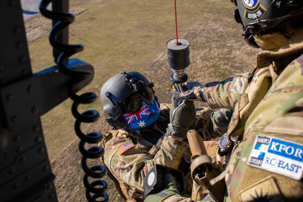 Teamwork! 💪 Sgt. Thomas Foose, a crew chief with @WANationalGuard helps Sgt. Abraham Boxx, a critical care flight paramedic, into a UH-60 Black Hawk during a dynamic hoist lift at Camp Bondsteel, Kosovo, Jan. 2, 2021. #PicOfTheDay | #Readiness 📸 by Sgt. Jonathan Perdelwitz