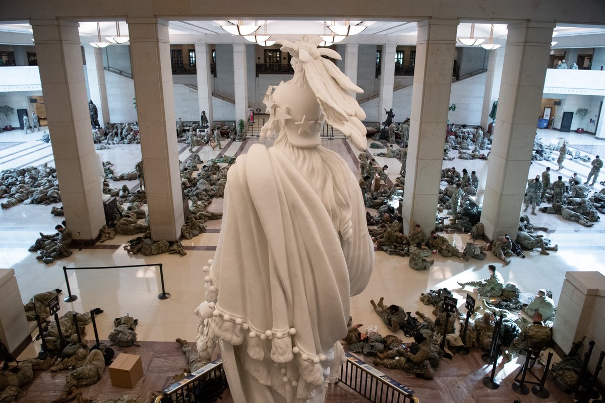 ajplus's tweet photo. Hundreds of National Guard members are on 24-hour watch in the U.S. Capitol, many sleeping in the hallways.

A new 7-foot fence and other security measures are in place after the pro-Trump riots last week. About 20,000 Guard members are ordered to D.C. ahead of the inauguration. https://t.co/uwKy61bnXY