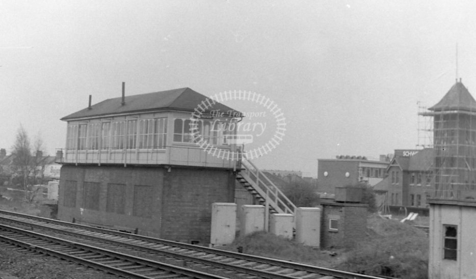 The Hendon mainline signal box pictured in 1977. In the background is the Schweppes factory. The scaffolding on it is perhaps a portent of what was to become of it.Image from The Transport Library