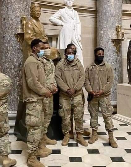 National Guard troops protecting the Capitol,... having their photo taken with Rosa Parks' statue inside the Rotunda: