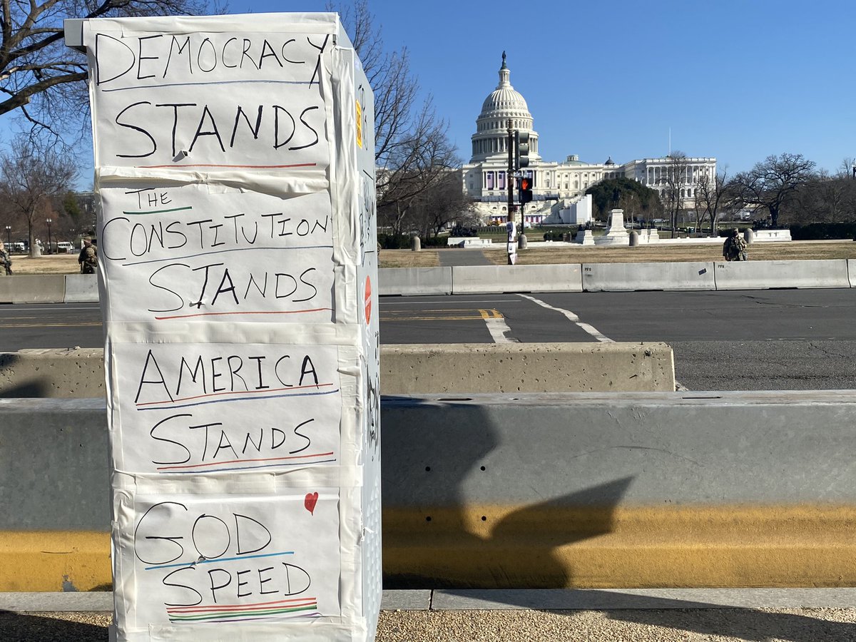 A handwritten sign on 3rd Street overlooking Capitol says, "Democracy stands. The Constitution stands. America stands. Godspeed."