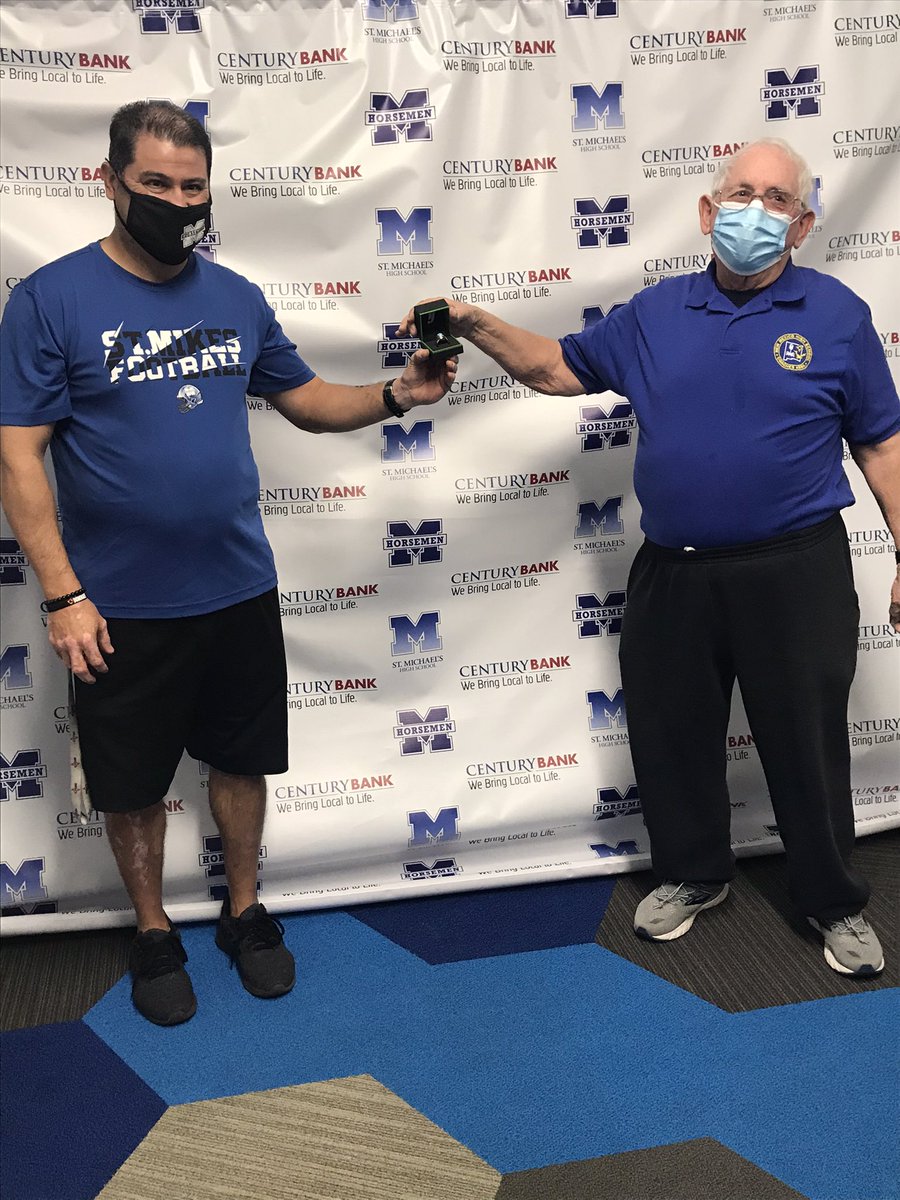 Joey Fernandez being awarded a ring from the NMHSCA President Allan Lockridge for coaching excellence in Football, Boys &amp; Girls Track <a href="/sfnmsports/">New Mexican Sports</a> <a href="/SportsPrimo/">Sports Primo</a> <a href="/JournalNorth/">Journal North</a> <a href="/StMikesBlueCrew/">Official SMHS Blue Crew</a>