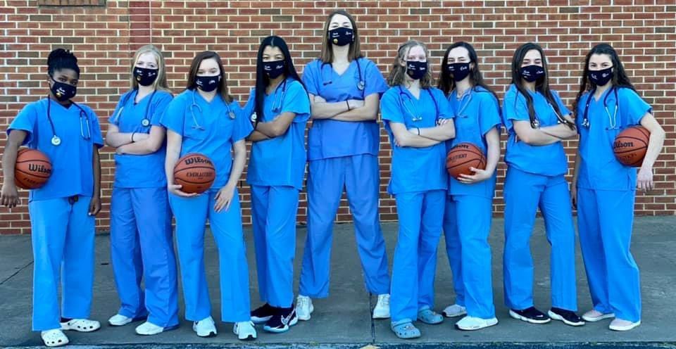 AmeliaCountyHS's tweet photo. 2020-2021 Amelia County High School Lady Raiders team photoshoot honoring healthcare workers! #RaidersRISE 💚💛❤️ https://t.co/xY0MJEEb9m