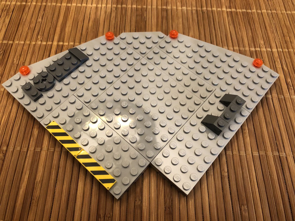 Then the same plates as in the first layer go on top, giving us a section as thick as a regular block. A little decoration goes on top - warning tape and lights, and two devices. The plate goes over one quadrant.  #LEGO  