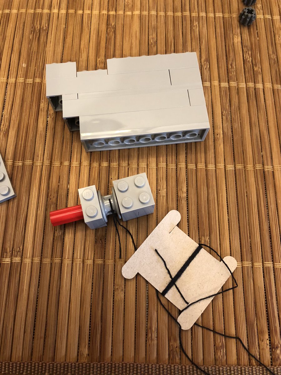 A really long shaft goes in this device here, then all these pieces are going to make the wall next to it. The first interesting part is this pulley with a crankshaft.  #LEGO  