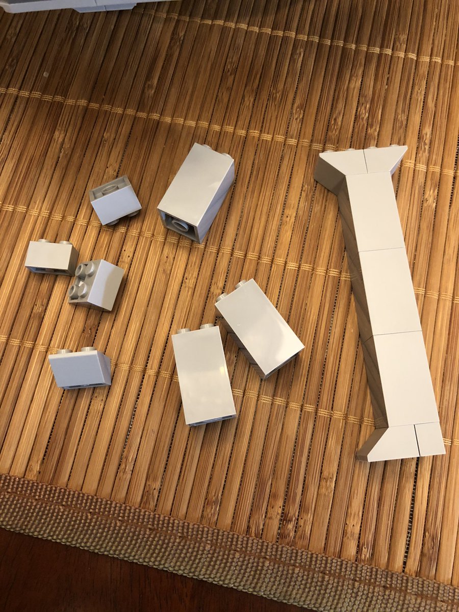 Two columns go opposite the decorative doorway. Secure them to the existing spokes, and put another layer across the top for stability.  #LEGO  