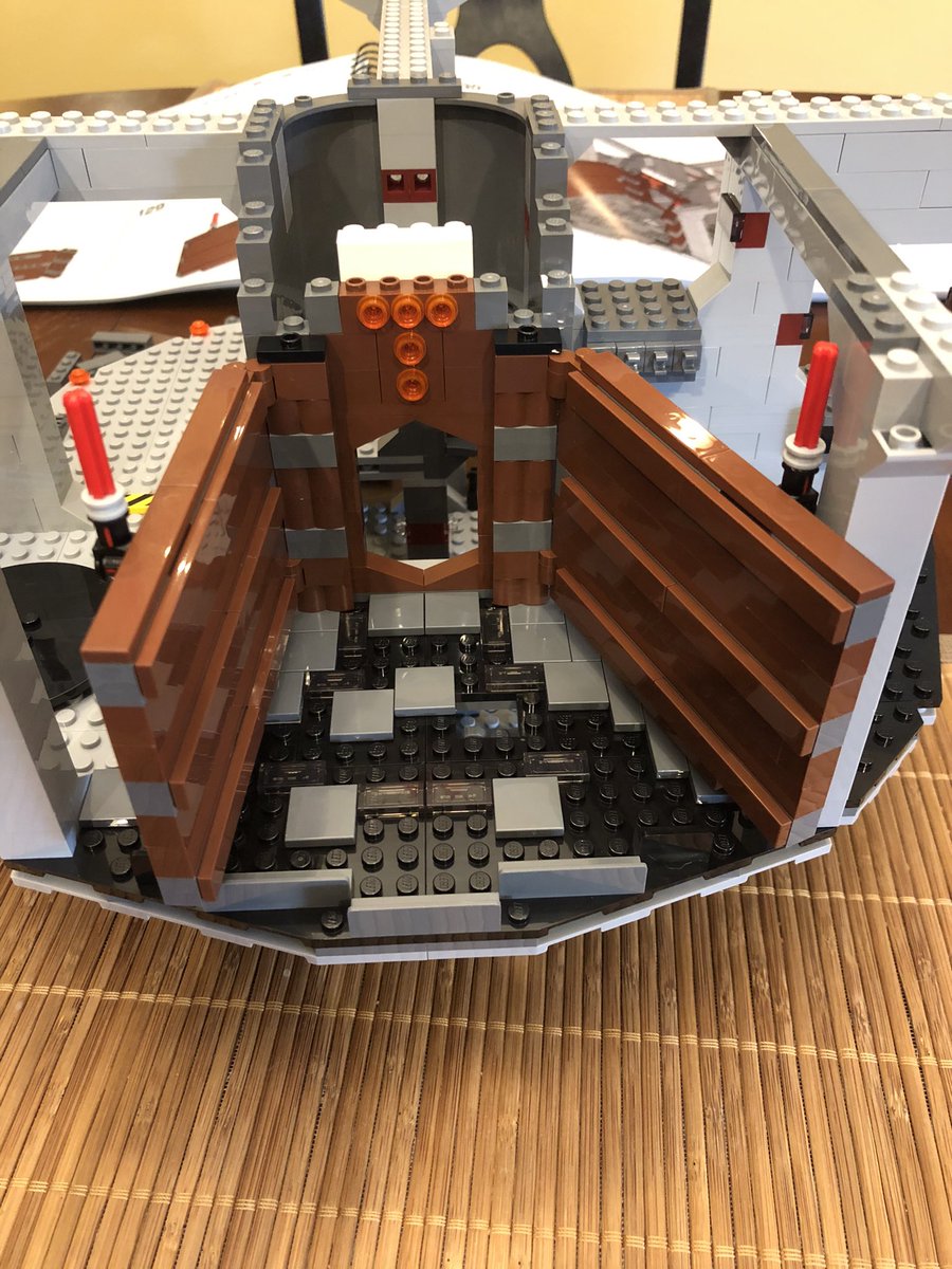 Some flat plates go on the pegs, giving the wall a polished look. Build another wall, hinged the other way, and attach them to either side of the door - figure out what it is yet? Then a few more layers go above the door.  #LEGO  