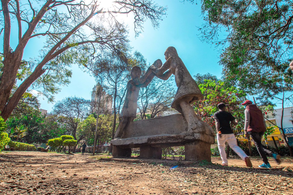 Back to the garden.The original metallic benches are said to have been smelted to make weapons in World War Two.One of the current benches is watched over by two figures holding a child. Apparently inspired by a woman who gave birth there as the sculptor was commencing work.