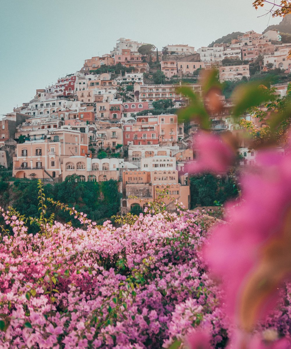This cliffside village painting a pretty pastel picture along the #AmalfiCoast is #Italy's #Positano! With a pebbled beach, a green mountain, & scenery of the buildings in the backdrop, it is a popular Italian attraction.

#mytravlution #holidaytourpackage #italylove #bucketlist
