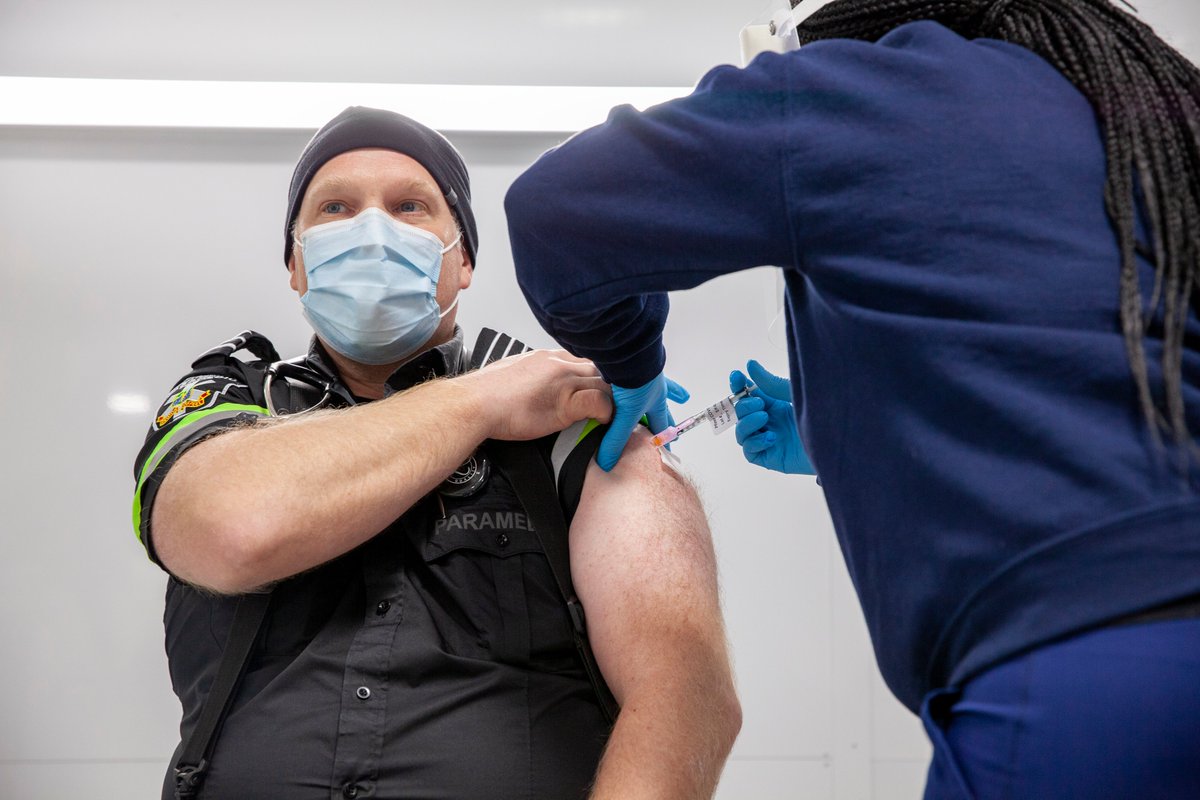 A THP staff member administers the COVID-19 vaccine to a Peel Region paramedic.