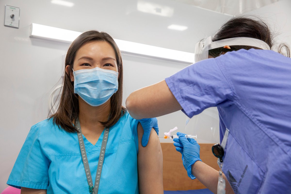 A THP doctor administers the vaccine to a front line health care worker.