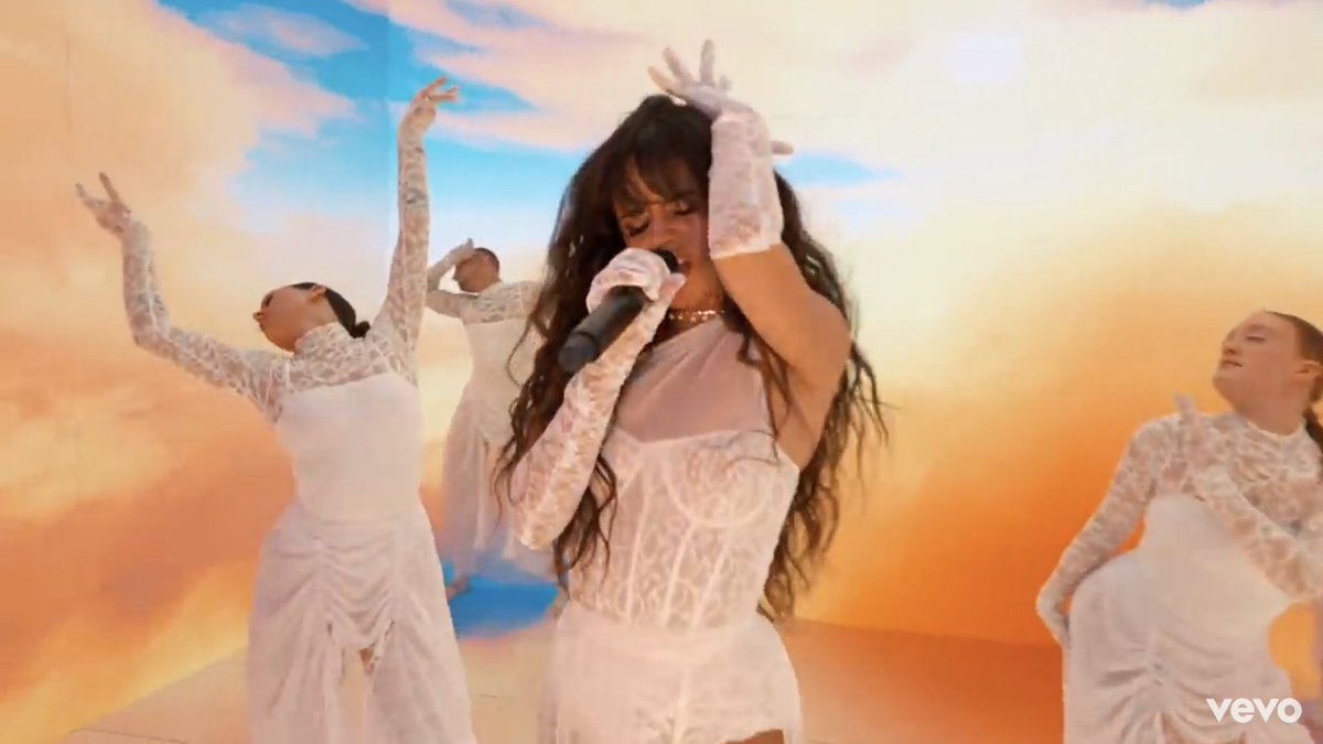 We can see Camila dressed in a white one-piece, alongside and same as some of her backup dancers. The colour white in many occasions is representing purity and innocence which in this case fits perfectly the scenario of this whole “We’re in Heaven” situation.