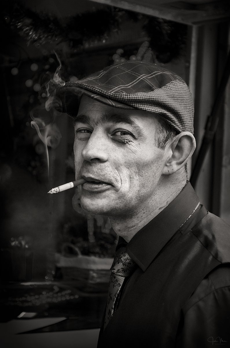 The Macaroon Seller #Galway He had stepped outside his stall to have a fag. I asked if I could take a photo. He agreed & removed the ciggie from his mouth. I asked if I could shoot him with the fag in, 'cos I thought it looked a bit 'James Dean' :-) 
#balckandwhite #people #galwa